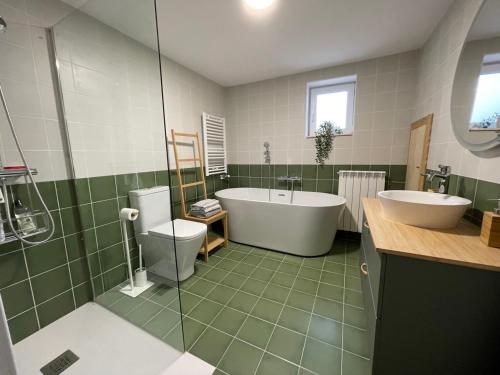 a bathroom with a tub and a toilet and a sink at Cal Frasco punt com - Pallars Jussà in Figuerola de Orcau
