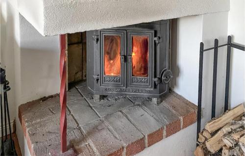 a fireplace in a room with a red ribbon at 3 Bedroom Cozy Home In Morgongåva in Morgongåva
