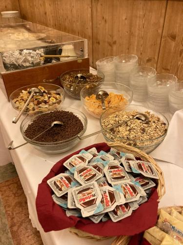 a table with many different types of food on it at Guesthouse - Cultural Center Gustav Mahler in Dobbiaco