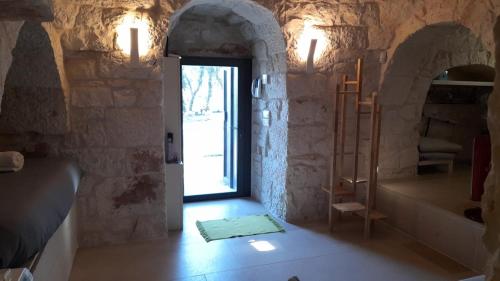 Cette chambre dispose d'une porte ouverte et d'un escalier. dans l'établissement Trullo Scrascia., à Ceglie Messapica