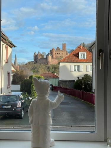 a teddy bear is looking out of a window at Ferienwohnung Bett & Burg in Wertheim