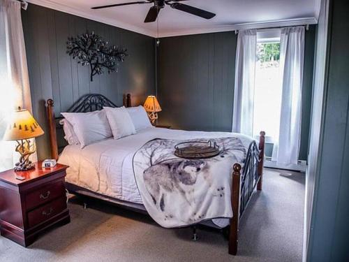 a bedroom with a large bed and a window at Ride from this Mini Mansion to all the ATV Trails in Berlin