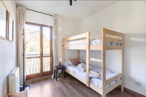 a bedroom with two bunk beds and a window at Mirador Del Río Piedra in Nuévalos