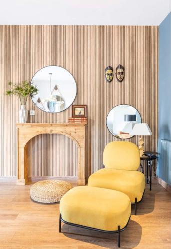a living room with two yellow chairs and a mirror at Mirador Del Río Piedra in Nuévalos