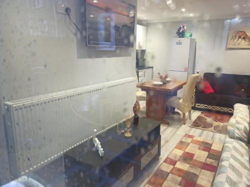 a living room with a couch and a table at Newport rental property Furnished studio near train station Free Wifi Parking in Newport