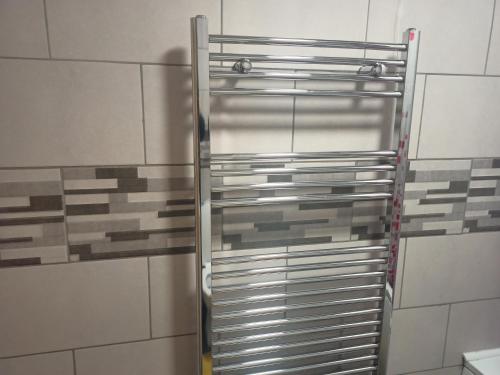 a shower in a bathroom with tiles on the wall at Newport rental property Furnished studio near train station Free Wifi Parking in Newport