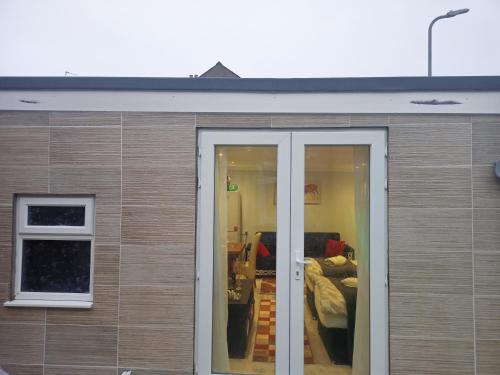 a building with sliding doors and a living room at Newport rental property Furnished studio near train station Free Wifi Parking in Newport