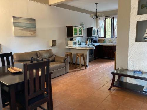 a living room with a couch and a table at Casa Sueno Colibri in Tamarindo