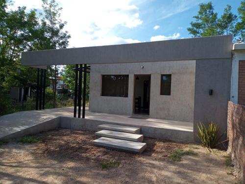 a small house with stairs in front of it at Casa Moderna in Mina Clavero