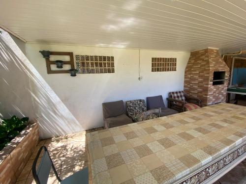a room with a bed and a couch and a fireplace at Pousada da Amália in Cidreira