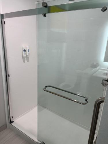 a shower with a glass door in a bathroom at Comfort Suites Clearwater - Dunedin in Clearwater