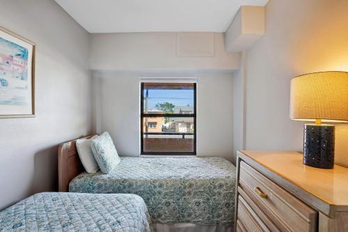 a small bedroom with a bed and a window at Villa Madeira 206 in St Pete Beach