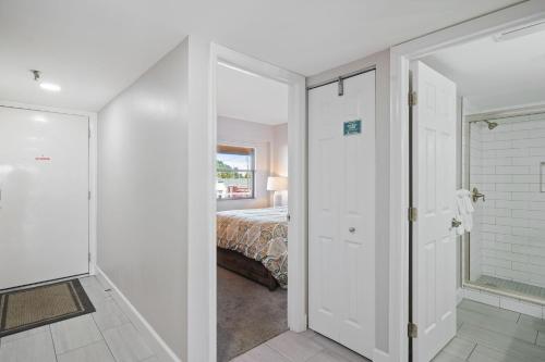 a bedroom with a bed and a door leading to a bathroom at Villa Madeira 206 in St Pete Beach