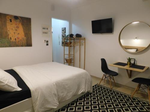 a bedroom with a bed and a mirror and a chair at Brand New Studio 1 in Komotini