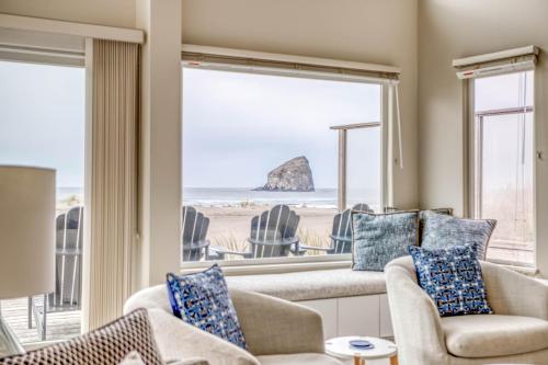 a living room with a view of the beach at Pacific City Sand Dollar - Meredith Lodging in Pacific City