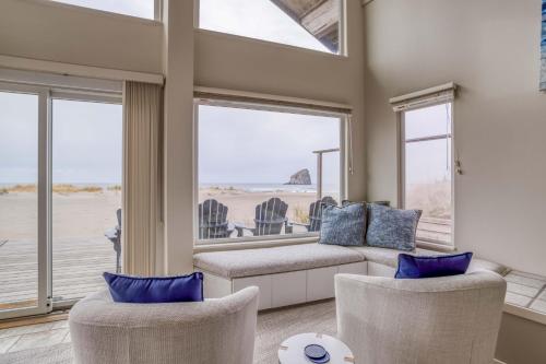 a living room with a couch and chairs and windows at Pacific City Sand Dollar - Meredith Lodging in Pacific City