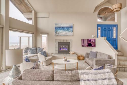 a living room with a couch and a table at Pacific City Sand Dollar - Meredith Lodging in Pacific City