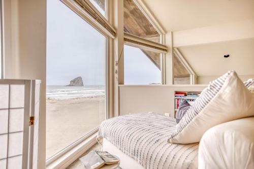 a bedroom with a view of the beach from a window at Pacific City Sand Dollar - Meredith Lodging in Pacific City