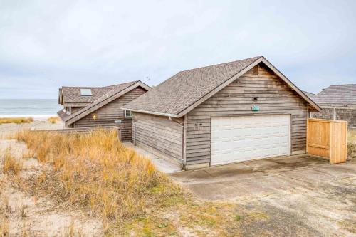 a house with a garage on the beach at Pacific City Sand Dollar - Meredith Lodging in Pacific City