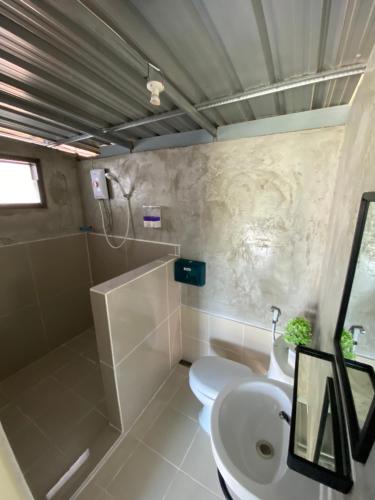 ein Bad mit einem WC und einem Waschbecken in der Unterkunft อุ่นฟ้าอิงดาว in Ban Kom