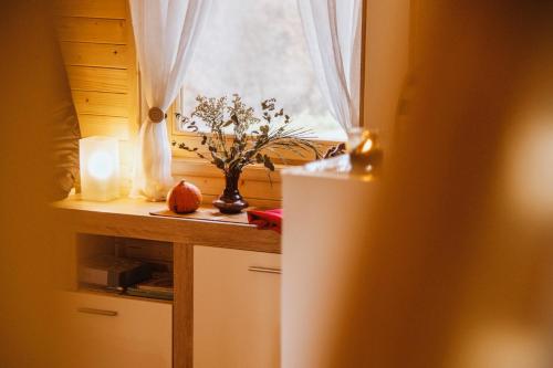 a kitchen with a window and a white refrigerator at Brvnaria in Slatina Varoš