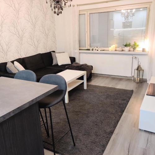 uma sala de estar com um sofá e uma mesa em Kodikas kaksio keskustassa em Pori
