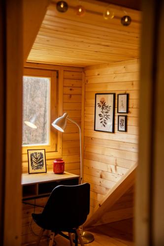 a desk and a chair in a wooden room at Brvnaria in Slatina Varoš