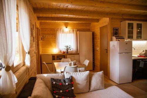 a living room with a couch and a refrigerator at Brvnaria in Slatina Varoš