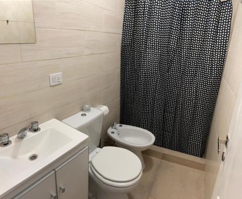 uma casa de banho com um WC e uma cortina de chuveiro preta em -BLA BLA... em Ushuaia