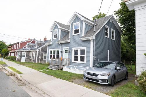 a car parked in front of a blue house at Captain Dan's Shanty in Saint Andrews