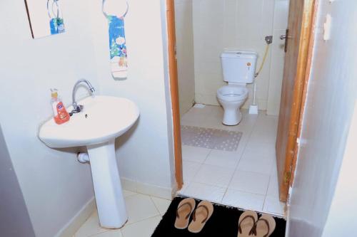 a bathroom with a sink and a toilet at Lovely 3 bedroom apartment, kisii in Kisii