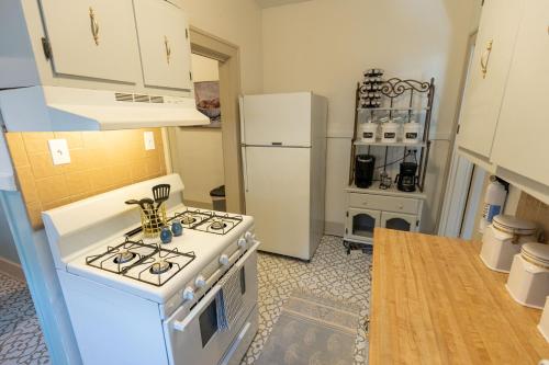 a kitchen with a white stove and a refrigerator at Historic Revival Midtown Memphis Duplex 64 Yes Pets Fast Wifi Free Parking in Memphis