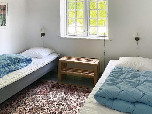 a room with two beds and a table with a window at Historic Water Tower Retreat-By Traum in Dannemare