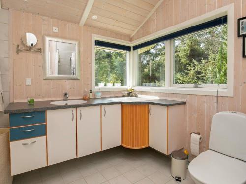 a kitchen with two sinks and two windows at Holiday home Væggerløse XLVI in Marielyst