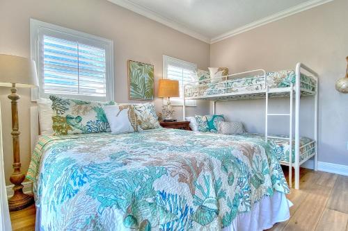 a bedroom with a bed and bunk beds at On The Rocks 2 in Clearwater Beach