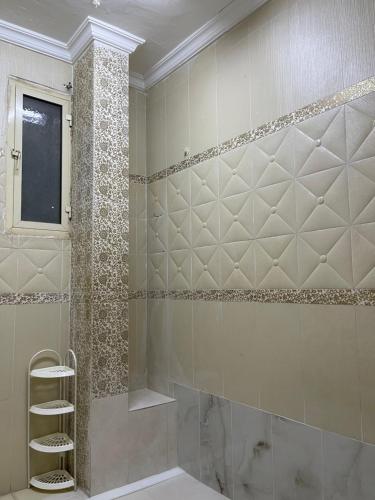 a bathroom with a walk in shower with a ladder at فيلا سلطانة in Medina