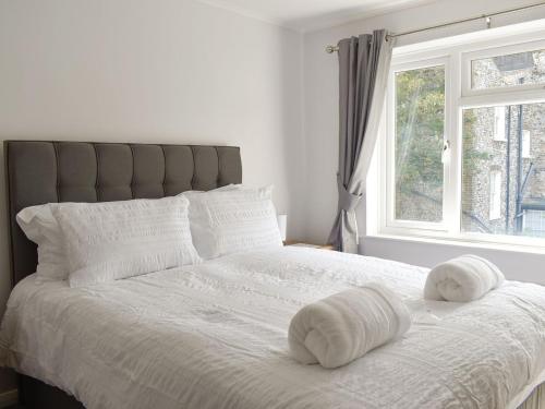 a bedroom with a bed with two towels on it at Stone Gardens in Broadstairs