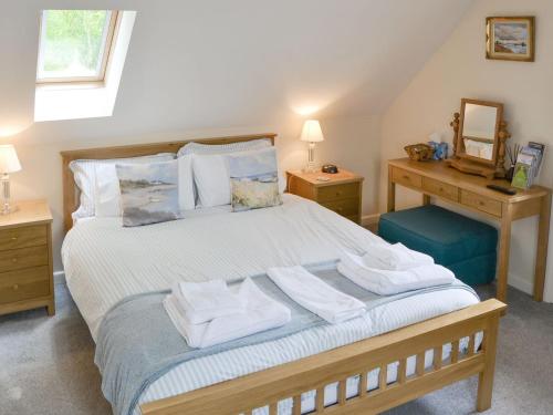 a bedroom with a bed with towels on it at Oak View Loft - Uk11926 in Lessingham