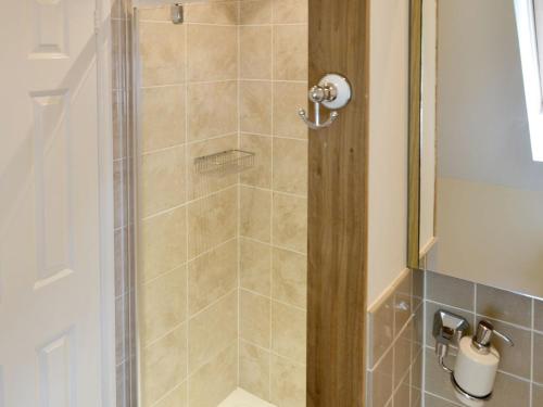 a shower with a glass door in a bathroom at Oak View Loft - Uk11926 in Lessingham