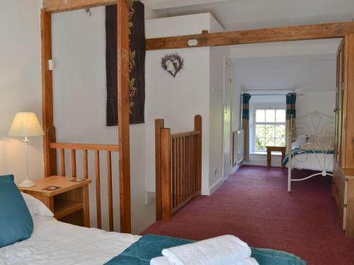 a bedroom with a bed and a doorway to a room at Cosy Nook in Ambleside