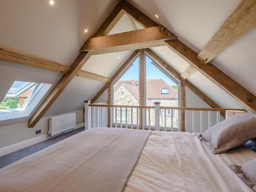a bedroom with a large bed in a attic at The Old Stable in Chew Stoke
