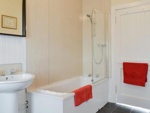 a bathroom with a white tub and a sink at The Bothy - Uk33907 in Rattray