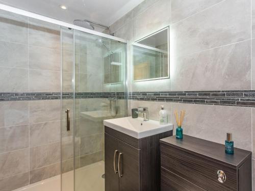 a bathroom with a sink and a glass shower at Court Terrace in Ripon