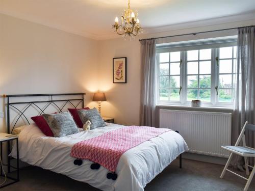 a bedroom with a bed and a window at Crown Cottage in Danehill