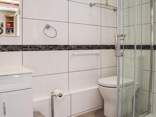 a bathroom with a toilet and a glass shower at Serenity Comfort in Sutton Coldfield