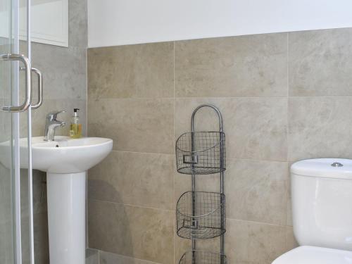 a bathroom with a toilet and a sink at Treacle Cottage - Uk12912 in Warton