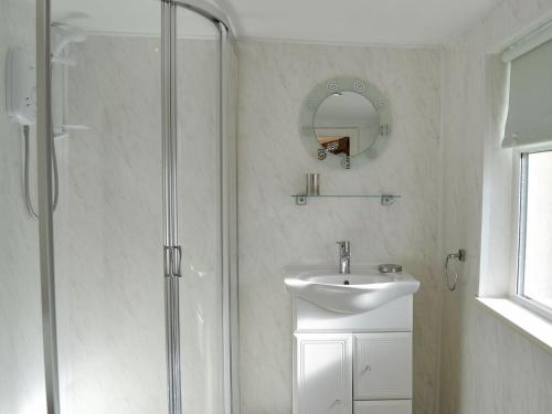 a bathroom with a shower and a sink at Cottonmill Cottage in Minnigaff