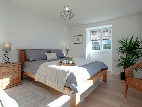 a bedroom with a large bed and a window at Dolphin Heights in Torquay