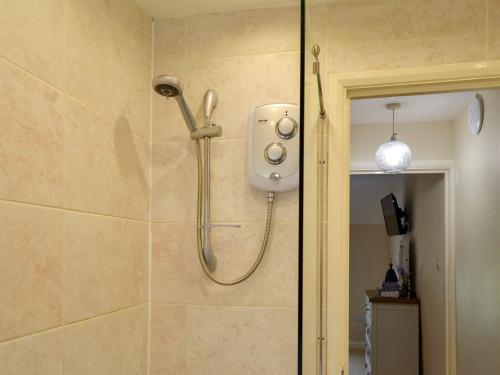 a shower with a shower head in a bathroom at Keldholme Cottages 2 - Uk11488 in Kirkbymoorside