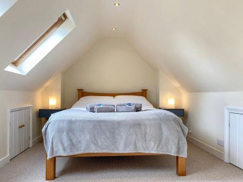 a bedroom with a bed with two pillows on it at The Old Fire Station in Ivybridge